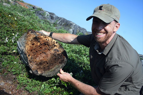 Alex Smith holds a log full of carpenter ants. Photos by Eric Scott