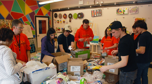 Fusion volunteers and students pack kits destined for Haiti.